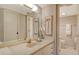 Bathroom offering a single sink vanity, decorative sconces, and a commode in the background at 8779 Midnight Pass Rd # 106H, Sarasota, FL 34242