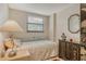 Bedroom showcasing a daybed, ornamental cabinet, blind-covered window, and lamp at 8779 Midnight Pass Rd # 106H, Sarasota, FL 34242