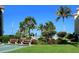 Features tropical landscaping, shuffleboard, and benches to enjoy the community, all under a beautiful blue sky at 8779 Midnight Pass Rd # 106H, Sarasota, FL 34242
