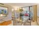 Elegant dining room boasts a glass table and chairs with natural light flowing in at 8779 Midnight Pass Rd # 106H, Sarasota, FL 34242