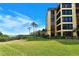Beautiful exterior with lush green grass and a view of the ocean and sky at 8779 Midnight Pass Rd # 106H, Sarasota, FL 34242