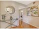 Hallway featuring parquet flooring, console table, decorative mirror, and artwork on the wall at 8779 Midnight Pass Rd # 106H, Sarasota, FL 34242