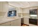 Bright kitchen featuring white appliances and pass-through to the living area at 8779 Midnight Pass Rd # 106H, Sarasota, FL 34242