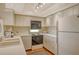 Clean kitchen with white appliances and ample countertop space at 8779 Midnight Pass Rd # 106H, Sarasota, FL 34242