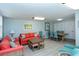 Cozy living room with bright decor and plenty of space for seating and dining at 8779 Midnight Pass Rd # 106H, Sarasota, FL 34242