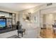 Bright living area with entertainment system, and open kitchen access at 8779 Midnight Pass Rd # 106H, Sarasota, FL 34242