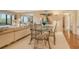 Inviting living and dining area featuring modern decor and sunroom with scenic views at 8779 Midnight Pass Rd # 106H, Sarasota, FL 34242