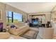 Cozy living room with a large window offering serene outdoor views and comfortable seating at 8779 Midnight Pass Rd # 106H, Sarasota, FL 34242
