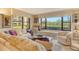 Spacious living room featuring a large window, built-in bookcases, and comfortable seating at 8779 Midnight Pass Rd # 106H, Sarasota, FL 34242