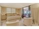 Serene main bedroom featuring a plush bed, soft lighting, and access to the sunroom at 8779 Midnight Pass Rd # 106H, Sarasota, FL 34242
