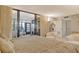 Spacious main bedroom showcases a large bed, balcony access, and natural light at 8779 Midnight Pass Rd # 106H, Sarasota, FL 34242
