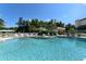 Beautiful community pool with lounge chairs and umbrellas at 8779 Midnight Pass Rd # 106H, Sarasota, FL 34242