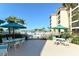 Inviting Island Reef pool area with comfortable seating and palm trees, perfect for relaxation and enjoying the outdoor atmosphere at 8779 Midnight Pass Rd # 106H, Sarasota, FL 34242