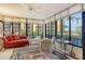 Relaxing sunroom with floor-to-ceiling windows offering beautiful views and ample seating at 8779 Midnight Pass Rd # 106H, Sarasota, FL 34242