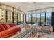Bright sunroom with seating, a ceiling fan, and expansive windows framing outdoor views at 8779 Midnight Pass Rd # 106H, Sarasota, FL 34242