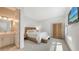Bedroom displays a wood bed frame, bench, wardrobe and ensuite bathroom at 8982 Baroque Ter, Sarasota, FL 34240