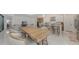 Bright, open-concept dining area with a view of the kitchen and living room; features a large table and ample seating at 8982 Baroque Ter, Sarasota, FL 34240