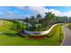 Elegant community entrance sign surrounded by lush landscaping and palm trees at 8982 Baroque Ter, Sarasota, FL 34240