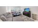 Comfortable living room featuring a plush sectional sofa, modern decor, and ample natural light from the large windows at 8982 Baroque Ter, Sarasota, FL 34240