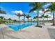 Palm tree lined community pool with light pavers and multiple lounge chairs at 8982 Baroque Ter, Sarasota, FL 34240
