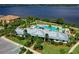 Aerial view of Tidewater Preserve community pool, clubhouse, and waterfront views in a beautiful waterfront community at 910 Tidewater Shores Loop # 107, Bradenton, FL 34208