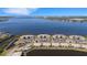 Aerial view of condos at Tidewater Preserve with beautiful water views and lush landscaping in a waterfront community at 910 Tidewater Shores Loop # 107, Bradenton, FL 34208