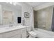 Bathroom featuring a tub with tiled shower and an all-white vanity at 910 Tidewater Shores Loop # 107, Bradenton, FL 34208