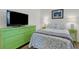 Cozy bedroom with a green dresser, decorative beach accents, and natural light at 910 Tidewater Shores Loop # 107, Bradenton, FL 34208