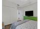 Well-lit bedroom with closet, dresser, and TV for added entertainment at 910 Tidewater Shores Loop # 107, Bradenton, FL 34208