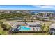 Community pool and cabana at Tidewater Preserve is surrounded by palm trees and lush landscaping at 910 Tidewater Shores Loop # 107, Bradenton, FL 34208