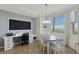 Bright dining room featuring a water view, white table and chairs, and a built-in desk area at 910 Tidewater Shores Loop # 107, Bradenton, FL 34208