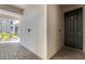 Covered entrance featuring a dark front door and brick-paved walkway at 910 Tidewater Shores Loop # 107, Bradenton, FL 34208