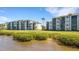 Exterior of Tidewater Preserve condos feature screened lanais with waterfront views and lush landscaping at 910 Tidewater Shores Loop # 107, Bradenton, FL 34208