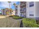 Exterior view of the building showcasing well-maintained landscaping and inviting balconies at 910 Tidewater Shores Loop # 107, Bradenton, FL 34208