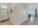 Hallway view leading to a bathroom and open living space, with closet at 910 Tidewater Shores Loop # 107, Bradenton, FL 34208