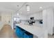 Bright kitchen with quartz countertops, white cabinets, stainless steel appliances, and island seating at 910 Tidewater Shores Loop # 107, Bradenton, FL 34208