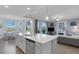 Open-concept kitchen with quartz countertops, and stainless steel appliances, with view of waterfront at 910 Tidewater Shores Loop # 107, Bradenton, FL 34208