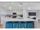 Bright kitchen with quartz countertops, white cabinets, stainless steel appliances, and island seating at 910 Tidewater Shores Loop # 107, Bradenton, FL 34208