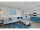 Bright living room and kitchen with white cabinets, stainless steel appliances, and accent blue starfish decor at 910 Tidewater Shores Loop # 107, Bradenton, FL 34208