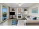 Bright living room with a waterfront view, white fireplace, coastal decor, and a comfortable couch at 910 Tidewater Shores Loop # 107, Bradenton, FL 34208