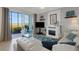 Comfortable living room with waterfront views, a white fireplace, and coastal decor throughout at 910 Tidewater Shores Loop # 107, Bradenton, FL 34208