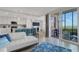 Open-concept living space with kitchen, island seating, and access to a screened-in porch with water view at 910 Tidewater Shores Loop # 107, Bradenton, FL 34208