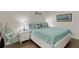 Cozy main bedroom with coastal decor, white furniture, and soft lighting at 910 Tidewater Shores Loop # 107, Bradenton, FL 34208