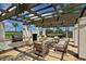 Outdoor kitchen with a built-in grill, fireplace, and seating area for entertaining guests at 910 Tidewater Shores Loop # 107, Bradenton, FL 34208