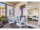 Relaxing patio with comfortable seating and serene view from sliding doors at 910 Tidewater Shores Loop # 107, Bradenton, FL 34208