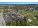 Aerial view of golf course community, showing the clubhouse, tennis courts, pool, and surrounding neighborhood at 9408 Glen Abbey Ln, Sarasota, FL 34238
