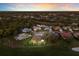 An aerial view showcases the home's location on a beautiful lot and landscaped garden at 9408 Glen Abbey Ln, Sarasota, FL 34238