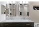 Bathroom featuring dual sinks, a dark vanity, and modern fixtures at 9408 Glen Abbey Ln, Sarasota, FL 34238