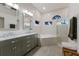 Luxurious bathroom with double vanity, tub, walk-in shower, and modern fixtures at 9408 Glen Abbey Ln, Sarasota, FL 34238