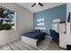 Stylized bedroom with a blue accent wall, comfortable decor, and an eye-catching desk at 9408 Glen Abbey Ln, Sarasota, FL 34238
